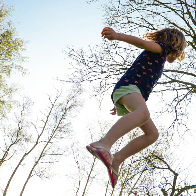 Child playing on trampoline